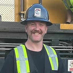 Mile High Fuels crew member in safety gear on a job site